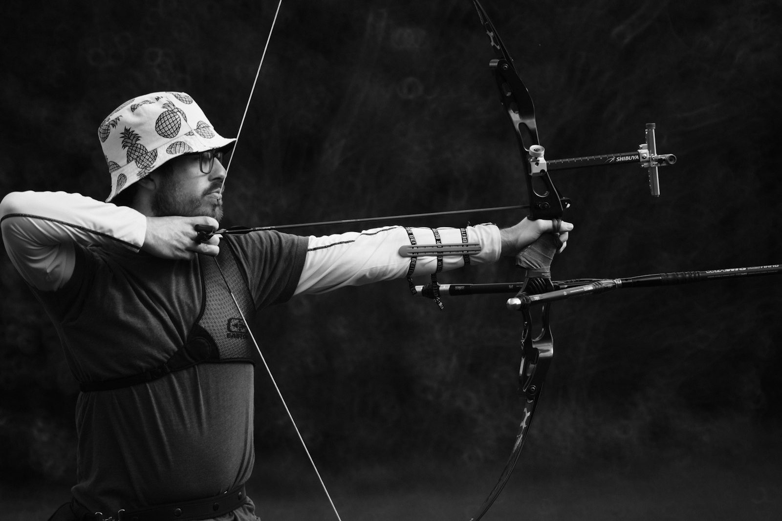 An archer at full draw with a compound bow